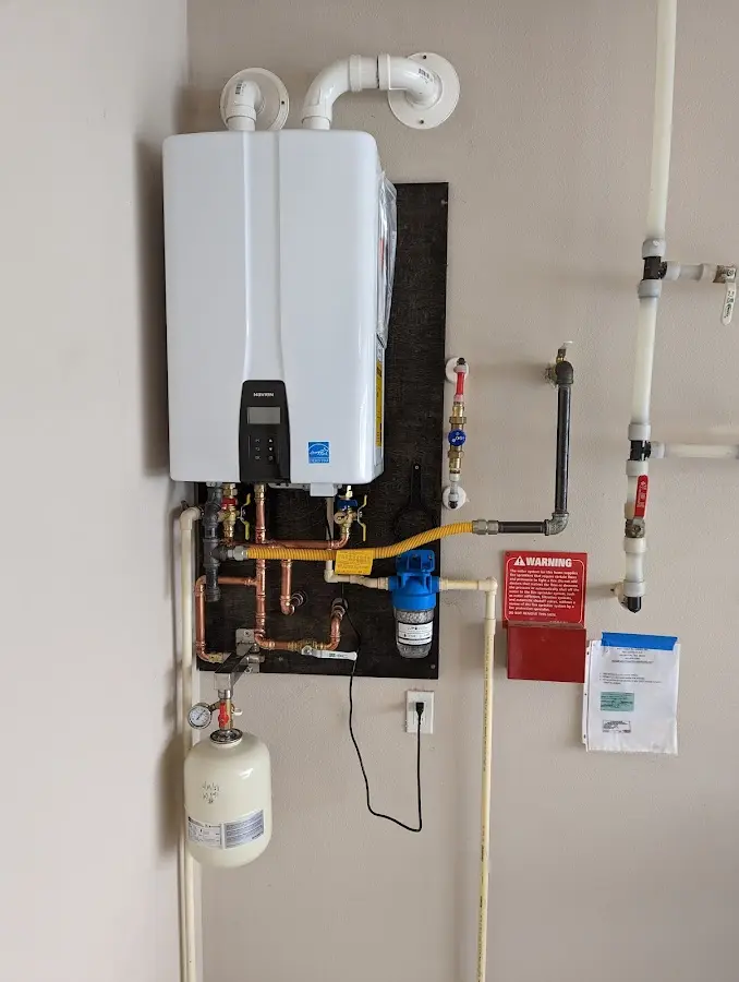 Professional plumber installing copper piping in a David City home